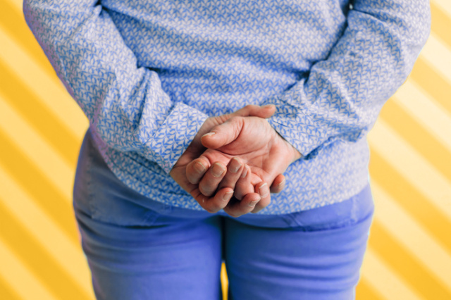 Person with hands clasped